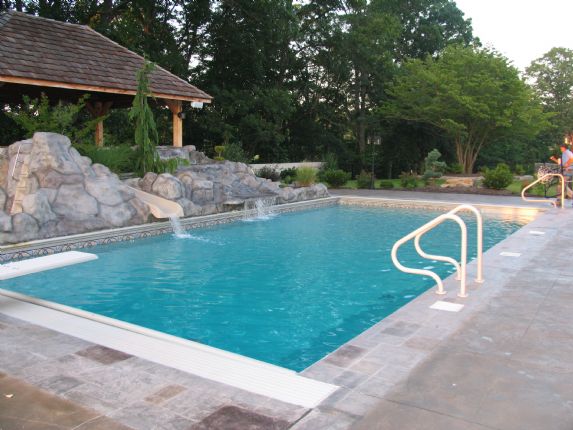 white stone surrounding inground pool