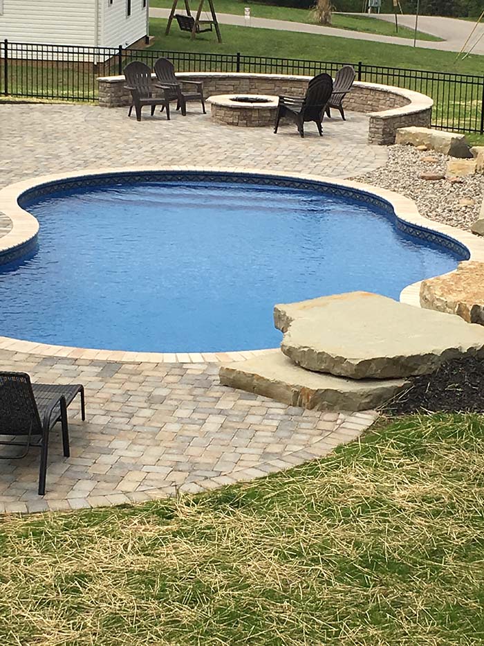Vinyl Pool, layered stone, table and chairs with firepit area