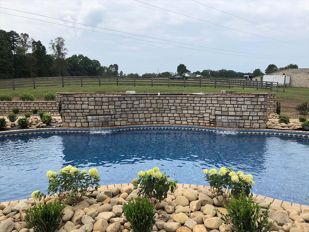 Vinyl pool with waterfall decorative rock wall 