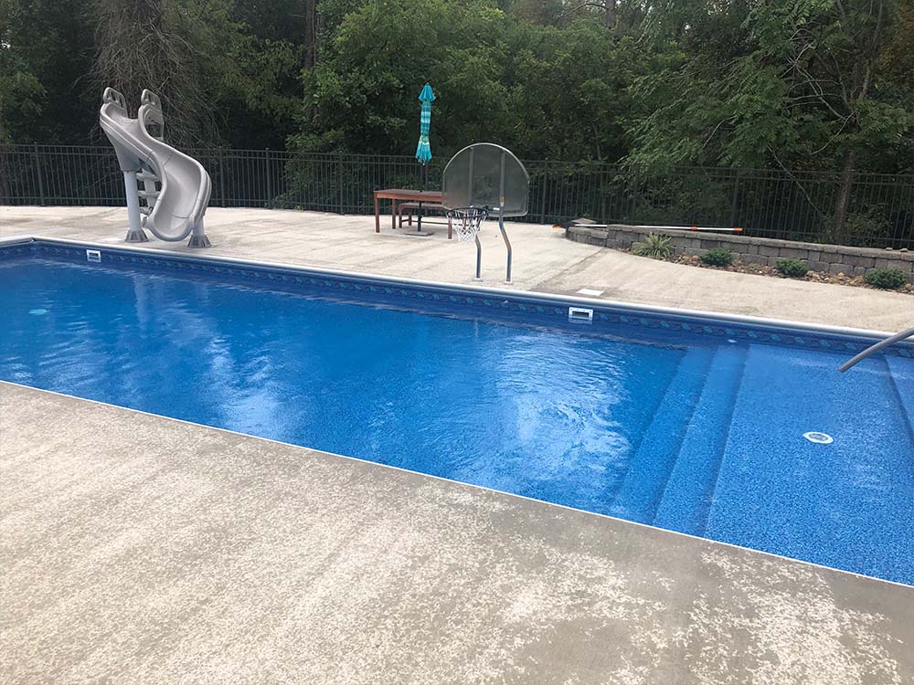 vinyl pool, open area with slide, retaining wall