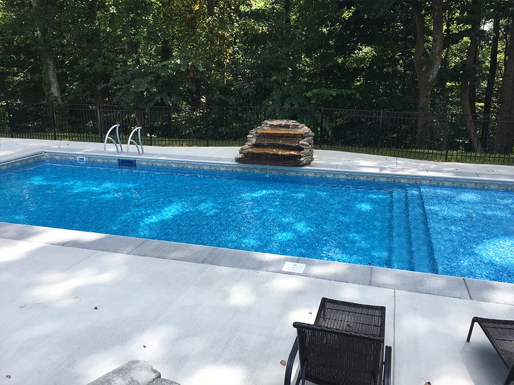Vinyl Pool tanning ledge, Rock waterfall and retaining wall.